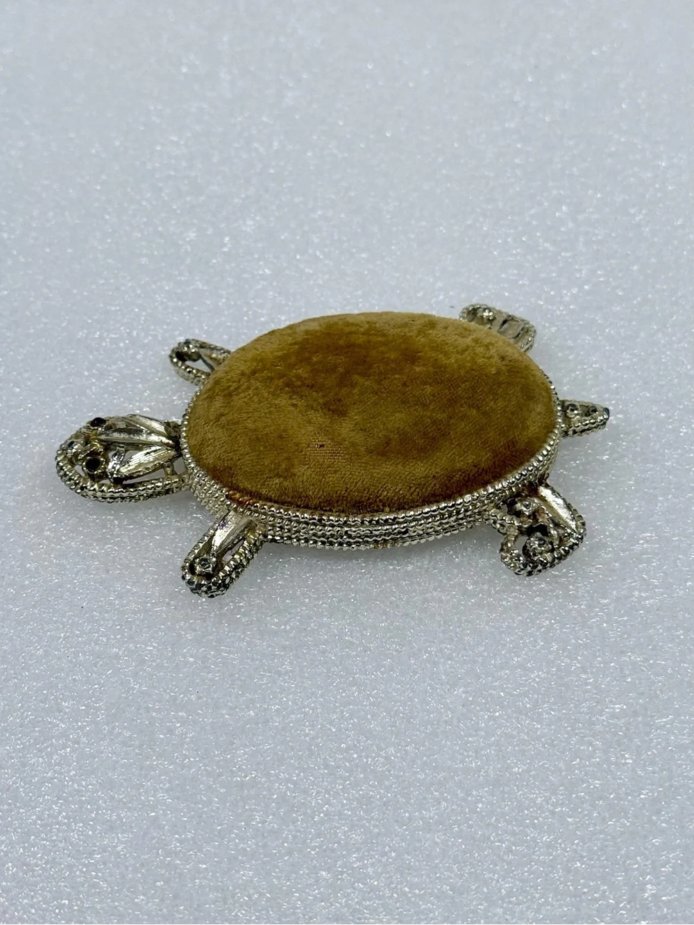 Vintage gold-tone metal turtle pin cushion featuring a textured body